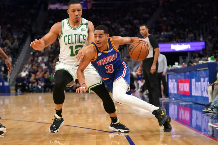 Mar 16, 2022; San Francisco, California, USA; Golden State Warriors guard Jordan Poole (3) dribbles past Boston Celtics forward Grant Williams (12) in the second quarter at the Chase Center. Mandatory Credit: Cary Edmondson-USA TODAY Sports/Sipa USA - Photo by Icon sport