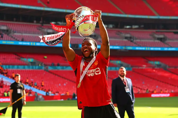 25th May 2024;  Wembley Stadium, London, England; FA Cup Final Football, Manchester City versus Manchester United; Willy Kambwala of Manchester United celebrates with the FA Cup trophy in front of the Man Utd fans   - Photo by Icon Sport