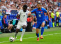 England's Bukayo Saka (left) and Slovakia's David Hancko battle for the ball during the UEFA Euro 2024, round of 16 match at the Arena AufSchalke in Gelsenkirchen, Germany. Picture date: Sunday June 30, 2024.   - Photo by Icon Sport