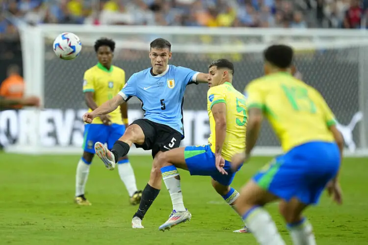 Jul 6, 2024; Las Vegas, NV, USA; Uruguay midfielder Manuel Ugarte (5) kicks the ball against Brazil midfielder Bruno Guimaraes (5) during the first half at Allegiant Stadium. Mandatory Credit: Lucas Peltier-USA TODAY Sports/Sipa USA   - Photo by Icon Sport