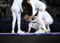 France's Auriane Mallo-Breton reacts after losing against Italy's team in the women's epee team gold medal bout between France and Italy during the Paris 2024 Olympic Games at the Grand Palais in Paris, on July 30, 2024. The rest of Team France came to her rescue to consol her while she recovers from her loss. Photo by Eliot Blondet/ABACAPRESS.COM   - Photo by Icon Sport