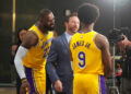 Sep 30, 2024; El Segundo, CA, USA; Los Angeles Lakers forward LeBron James (23) watches as ESPN reporter Dave McMenamin, (center) interviews son Bronny James (9) during media day at the UCLA Health Training Center. Mandatory Credit: Kirby Lee-Imagn Images   - Photo by Icon Sport